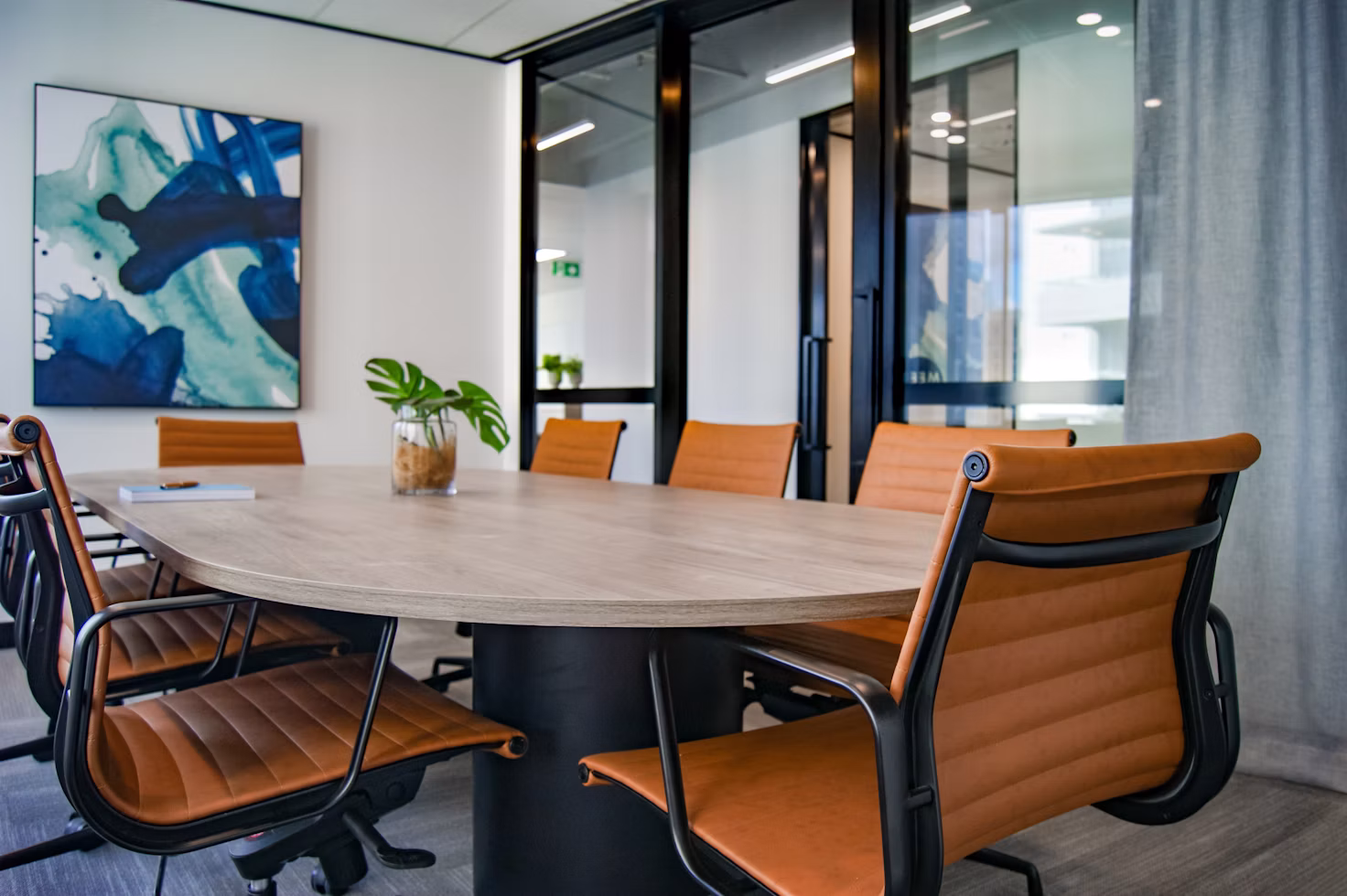 Bright office conference room with a long meeting table and chairs